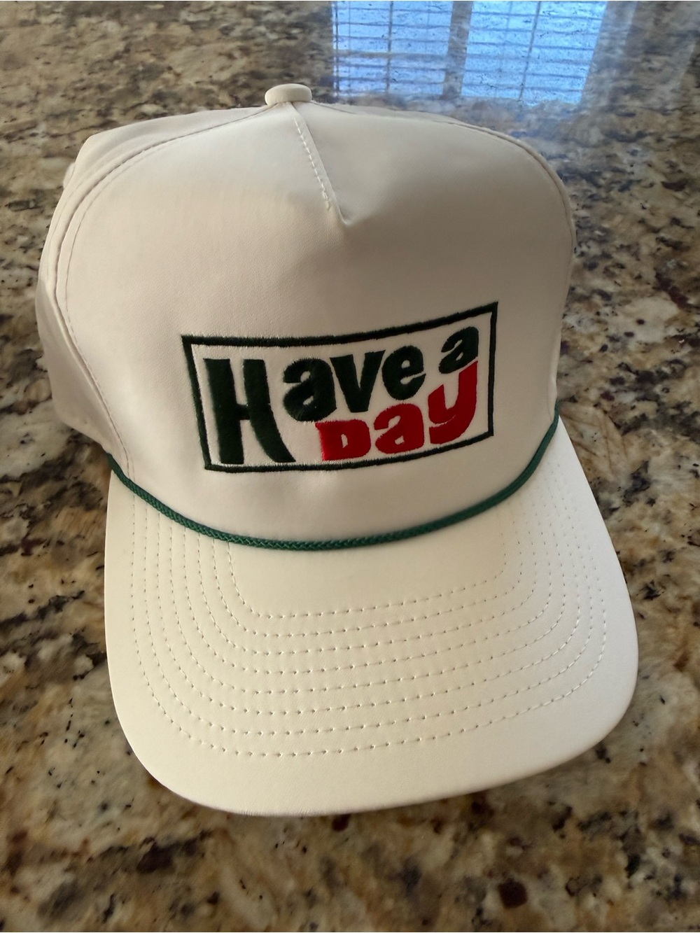 Have a Day White Trucker Hat with Green Piping and Green & Red Logo
